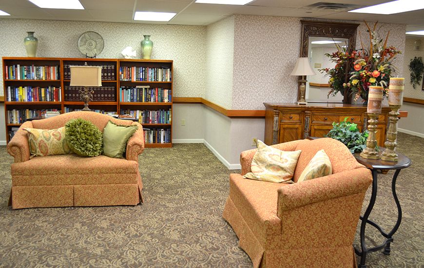A cozy living room with a well-stocked bookshelf, comfortable couches, and stylish decor.