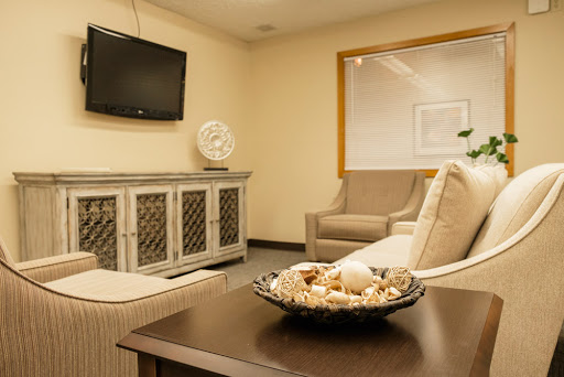 A cozy living room featuring a comfortable sofa, a TV, and decorative elements.