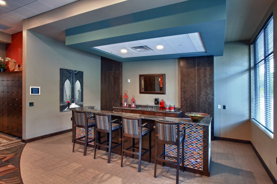 A modern bar area with seating and stylish decor.