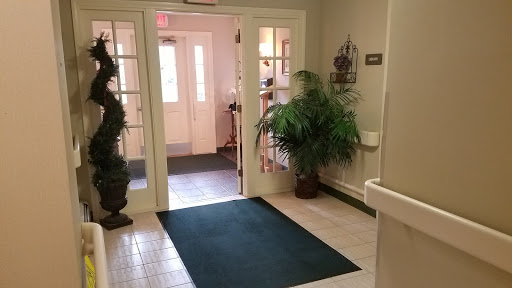 A welcoming entrance with soft carpeting and greenery.