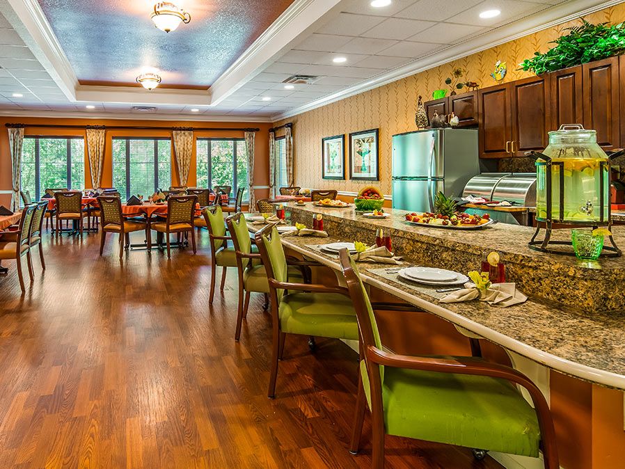 A cozy dining area with neatly arranged tables and chairs, warm lighting, and stylish decor.