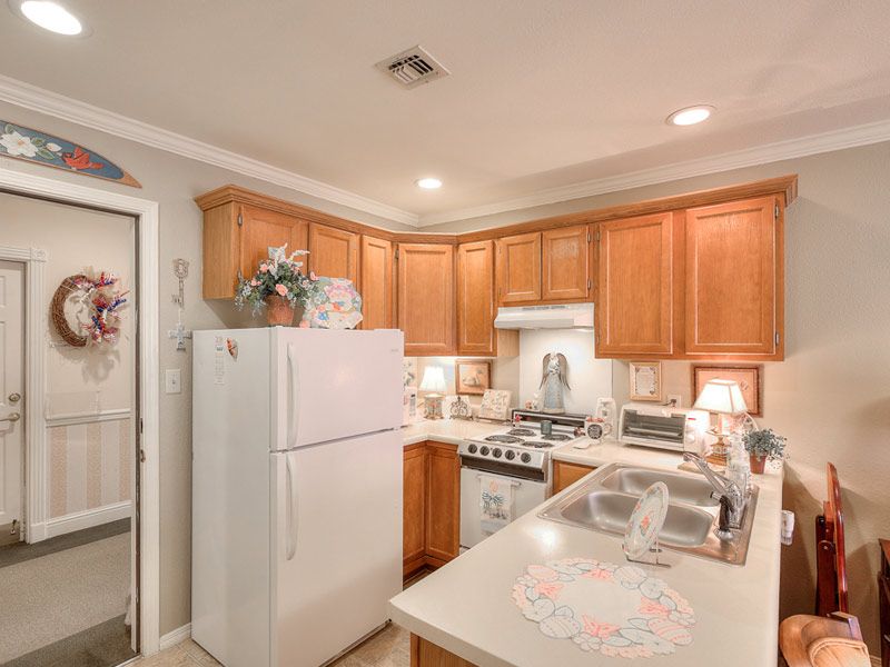 A cozy kitchen with wooden cabinets and modern appliances.