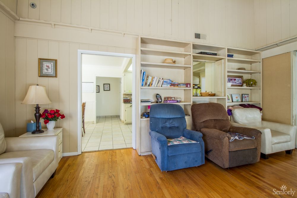 A cozy living room featuring recliner chairs and built-in bookshelves.