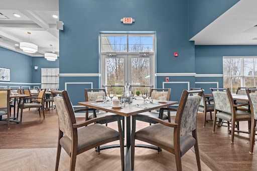 A cozy dining area featuring elegantly set tables with a view of the outdoors.