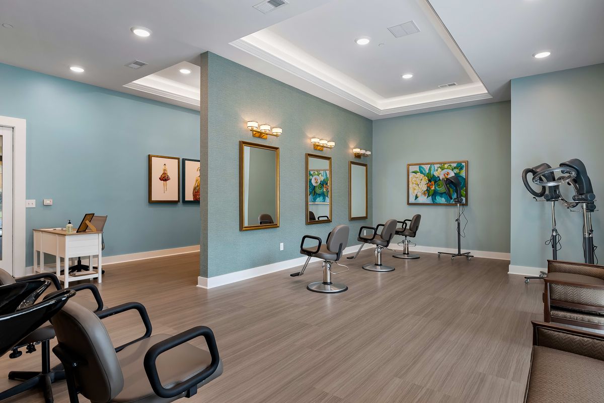A modern salon interior with chairs and mirrors, featuring stylish decor.