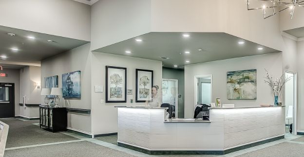 A modern reception desk area with contemporary decor and bright lighting.