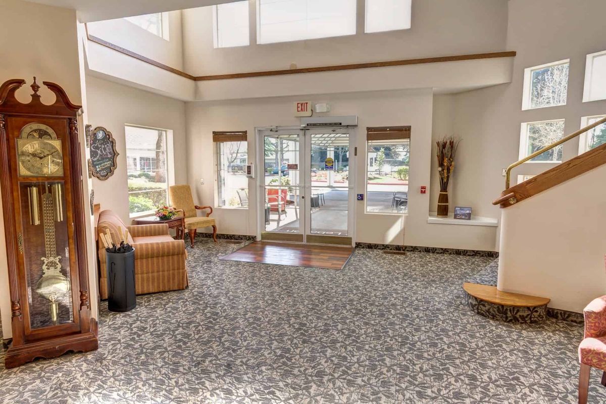 A bright lobby area with comfortable seating and large windows allowing natural light.