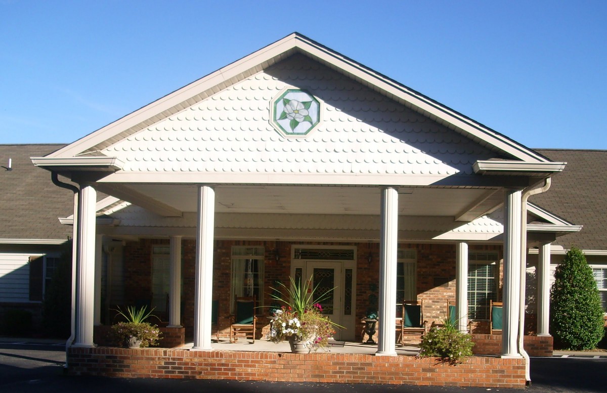 Front view of a building with columns and a porch.