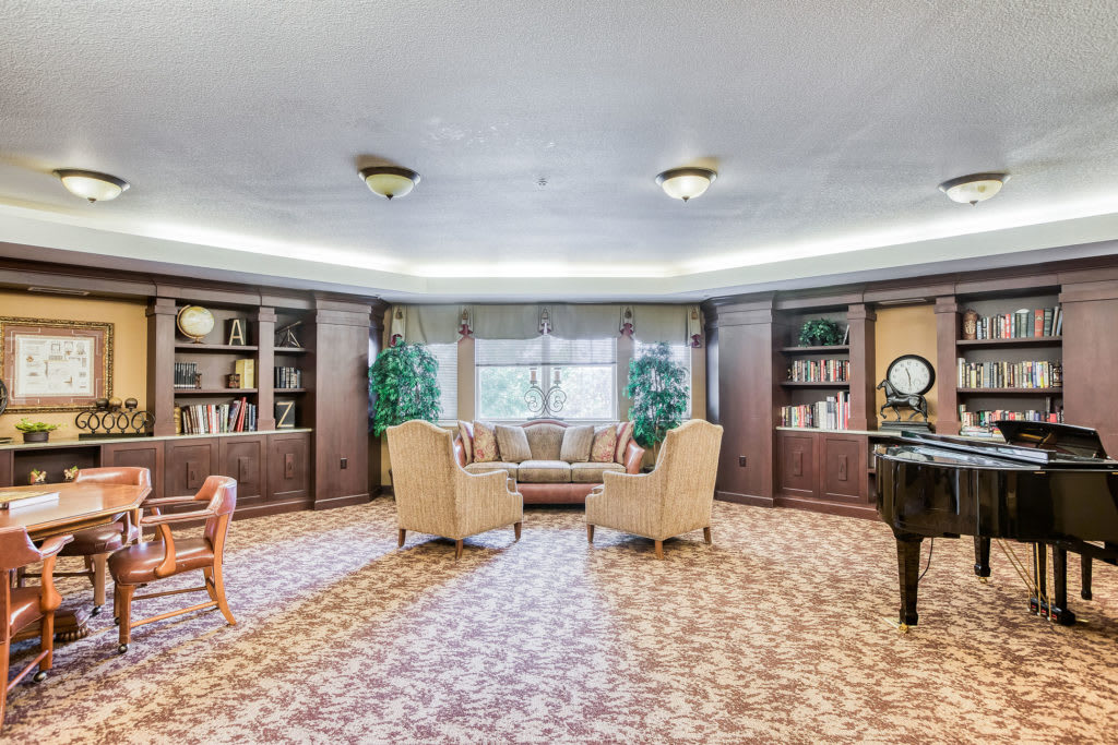 A cozy library interior with comfortable seating and bookshelves.