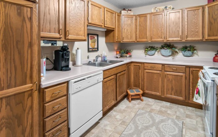A cozy kitchen with wooden cabinets and modern appliances.