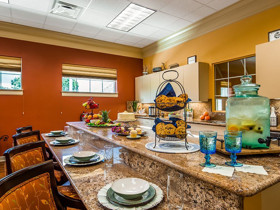 A well-decorated kitchen with a dining counter set for a meal.