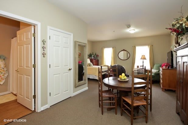 Cozy living and dining area with simple decor and wooden furniture.