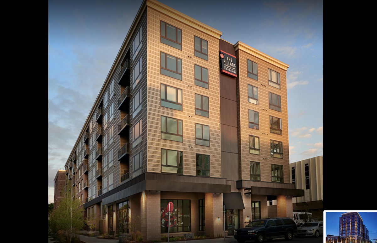 A modern hotel building with multiple floors in an urban setting.
