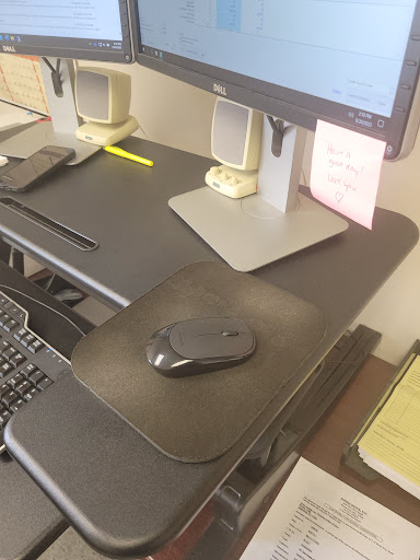 A well-organized office workspace featuring a computer setup with a mouse and keyboard.