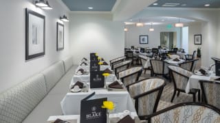 A neatly arranged dining area in a restaurant with tables set for service.