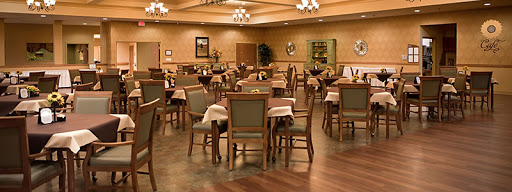 A spacious dining area with neatly arranged tables and chairs, ready to welcome guests.