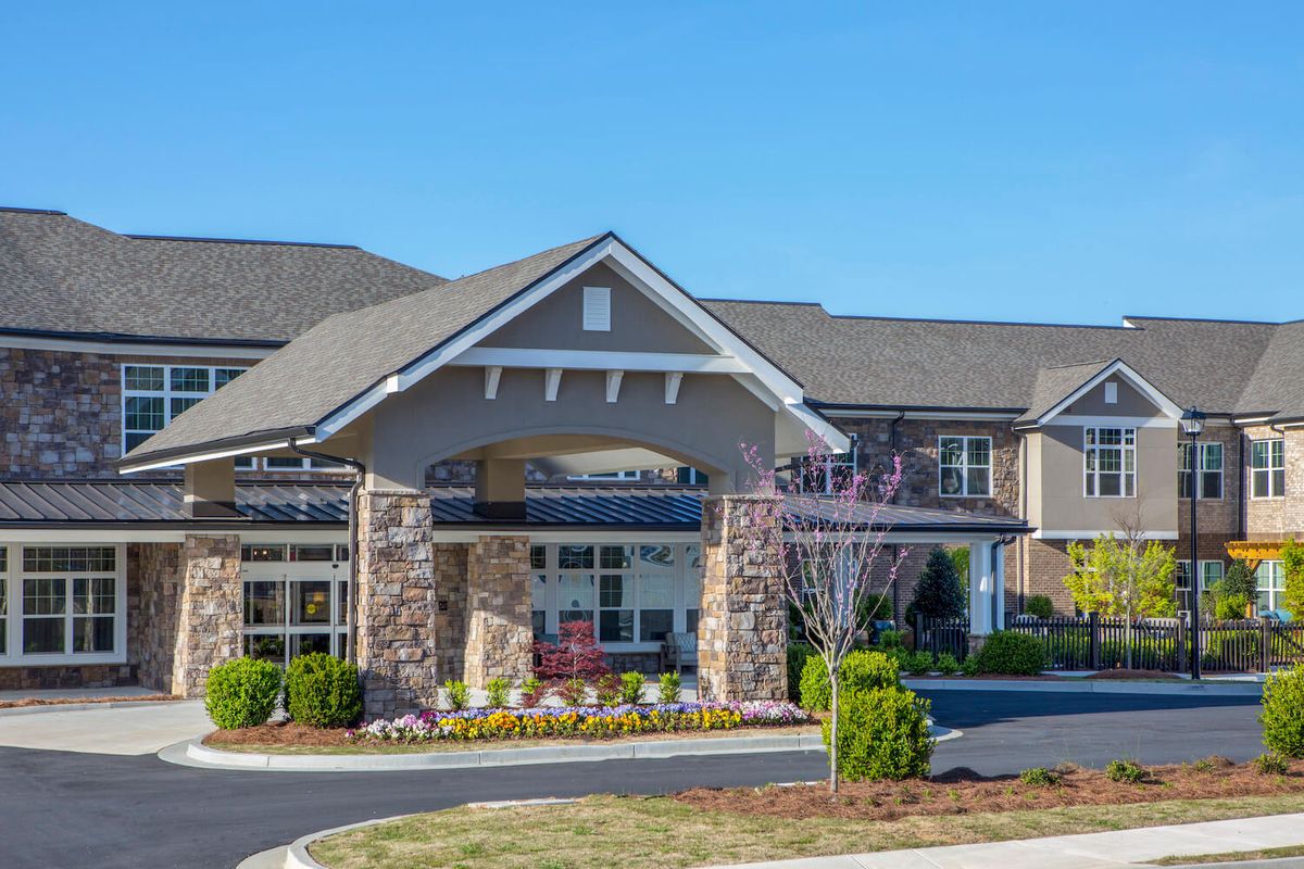 A view of a residential building with a landscaped entrance.