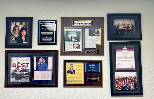 A collection of awards and recognitions displayed on a wall.