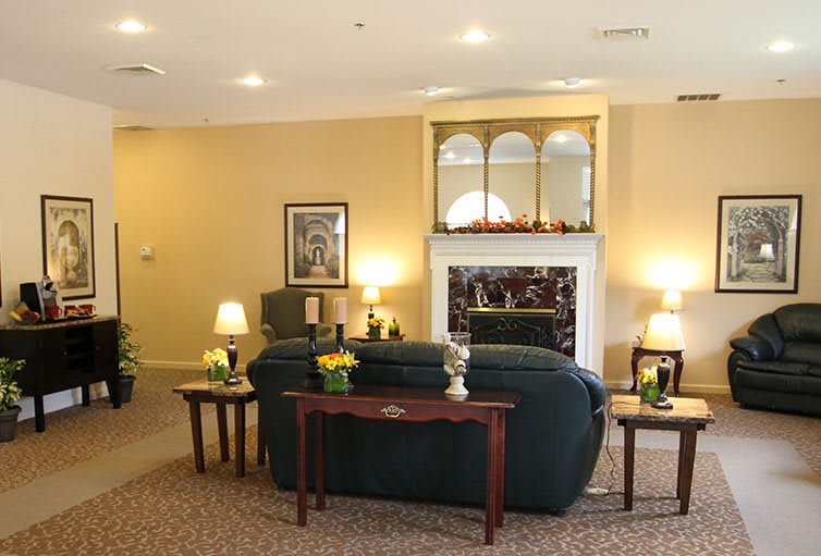 A cozy living room featuring a fireplace, sofas, and warm lighting.