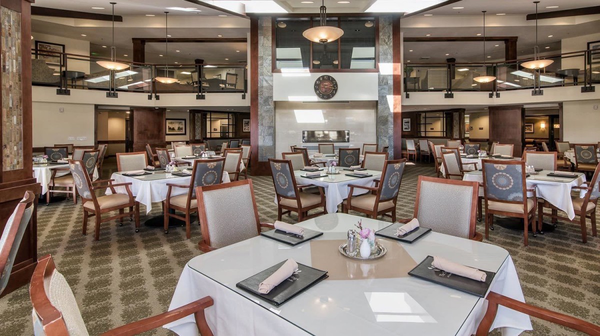 An elegant restaurant dining room with neatly arranged tables and chairs, ready for guests.