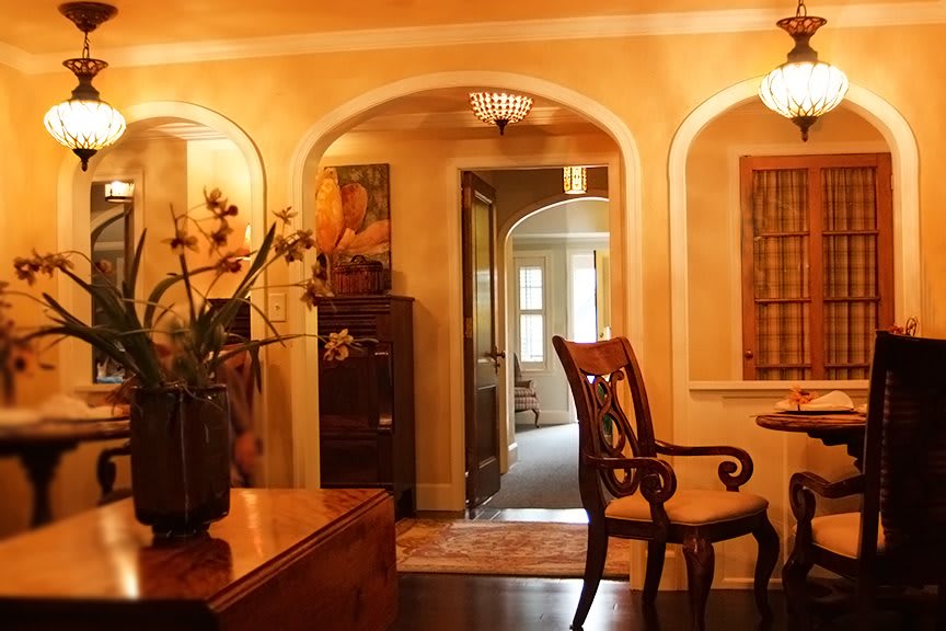 A warm and inviting living room with traditional decor and elegant archways.
