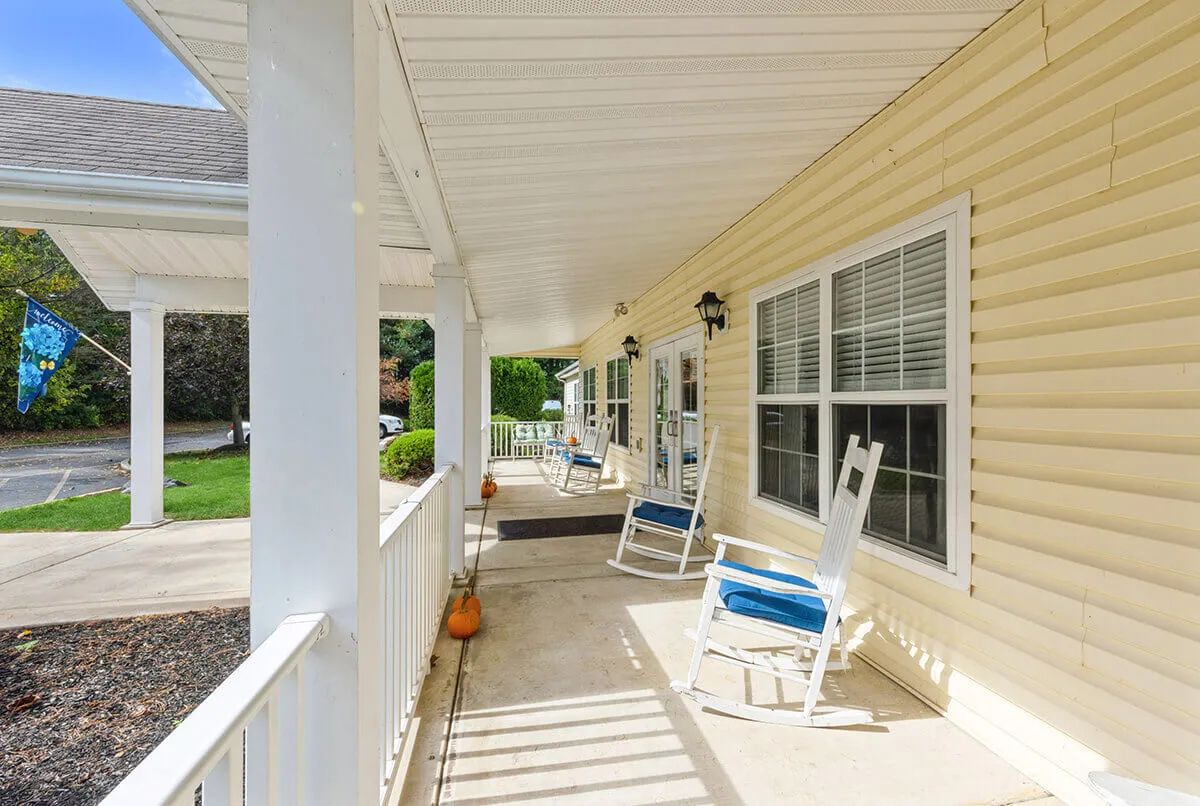 A sunny porch with rocking chairs and a cozy atmosphere.