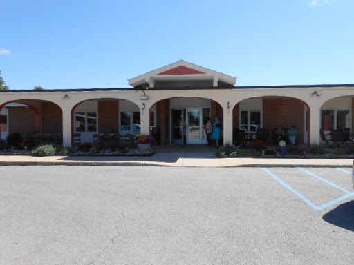 A welcoming entrance to a commercial building on a clear sunny day.