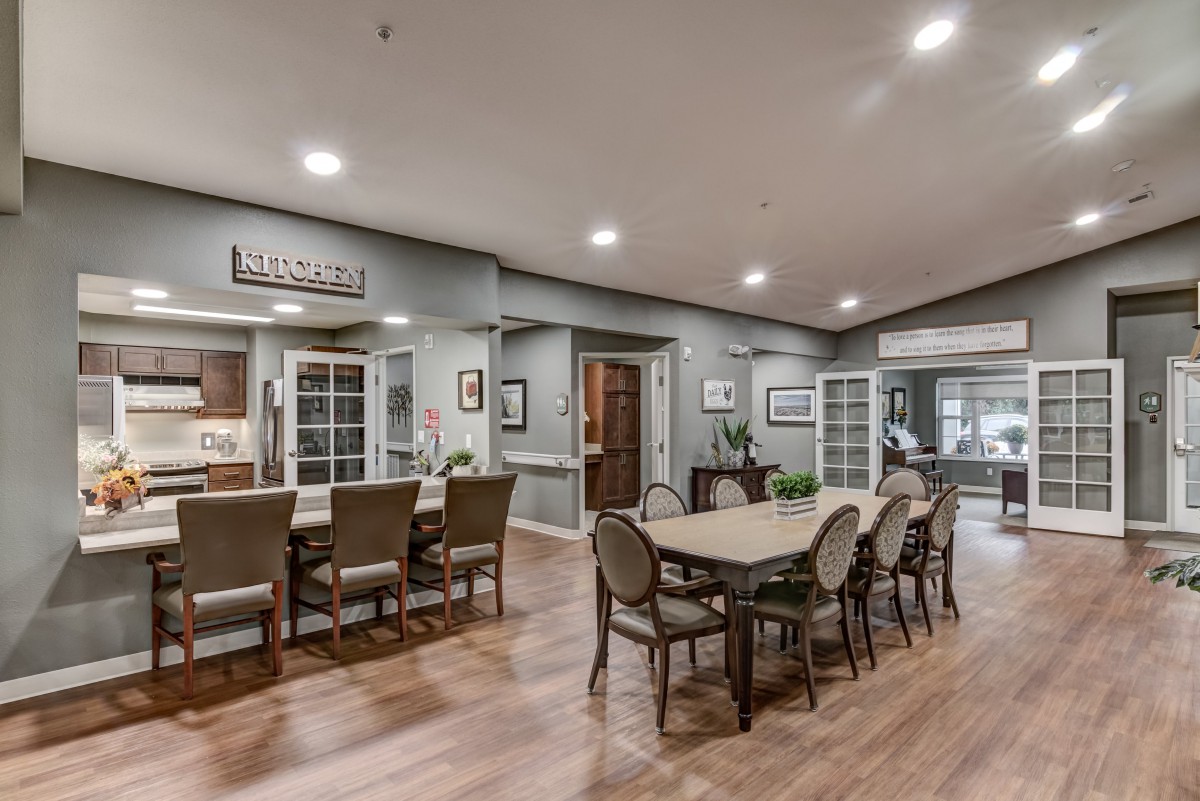 A modern dining and kitchen area with elegant furniture and decor.