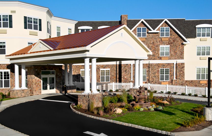 The exterior view of a hotel with a welcoming entrance and landscaped surroundings.