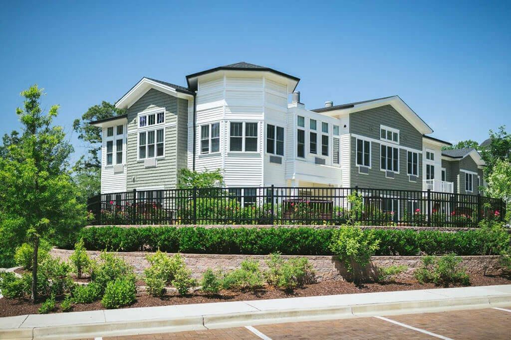 A modern residential house with large windows and well-maintained landscaping.