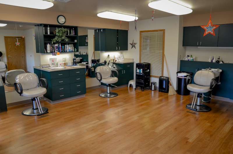 Interior view of a hair salon with styling chairs and mirrors.