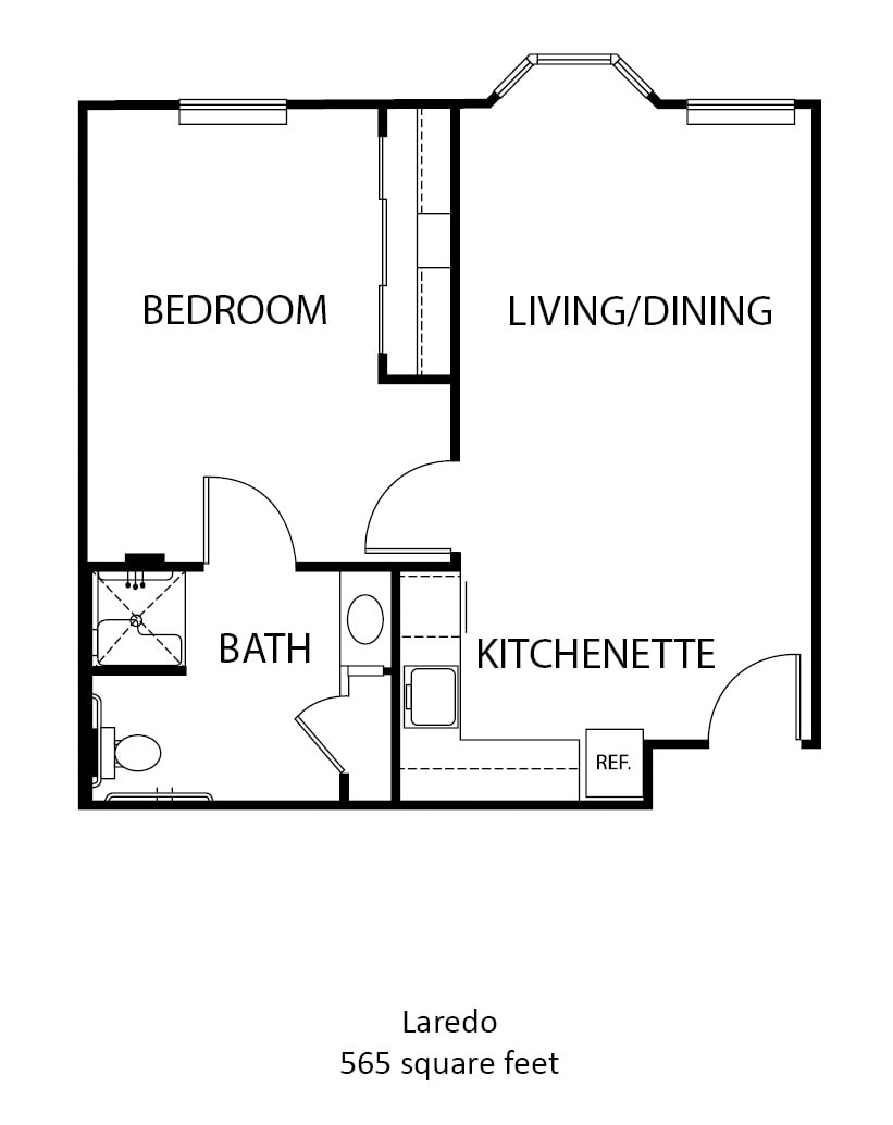 A floor plan of a one-bedroom apartment featuring a living/dining area, kitchenette, bathroom, and bedroom.