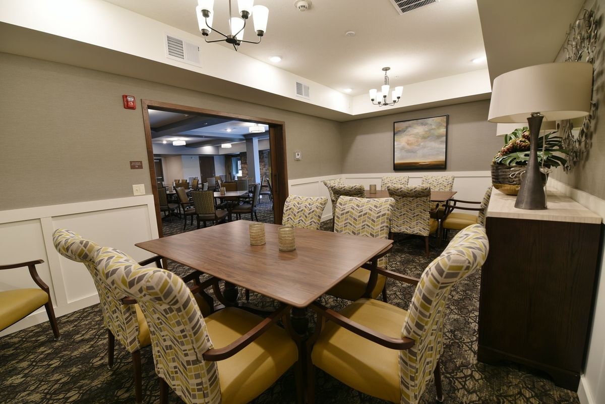 A cozy and elegant dining area with comfortable seating, warm lighting, and tasteful decor.