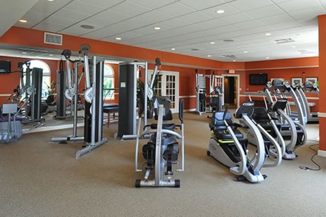 A well-equipped gym with various exercise machines.