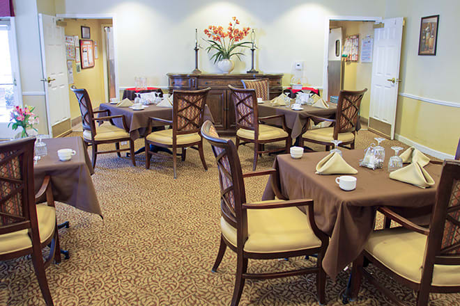 A cozy dining area with neatly arranged tables and chairs.