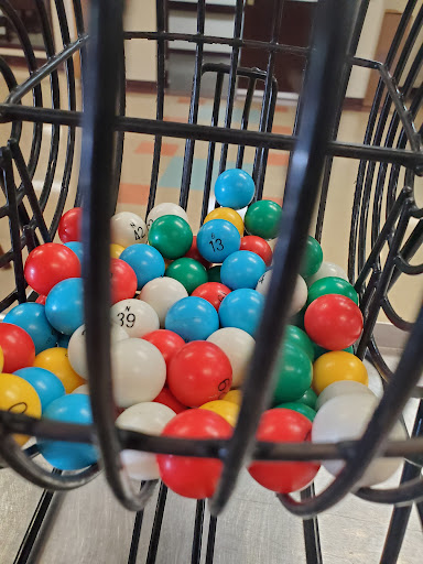 A vibrant assortment of bingo balls inside a metal cage, ready for the next game.