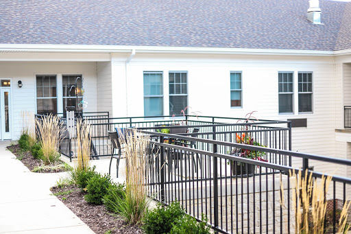 A modern outdoor patio area featuring seating and decorative plants.