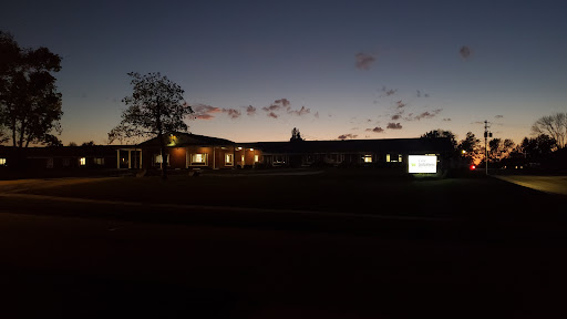 A serene view of a building illuminated at dusk.