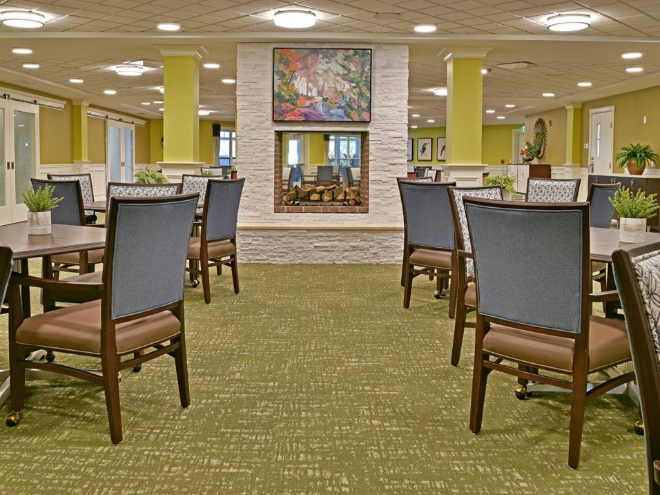 A modern dining area with neatly arranged tables and chairs.