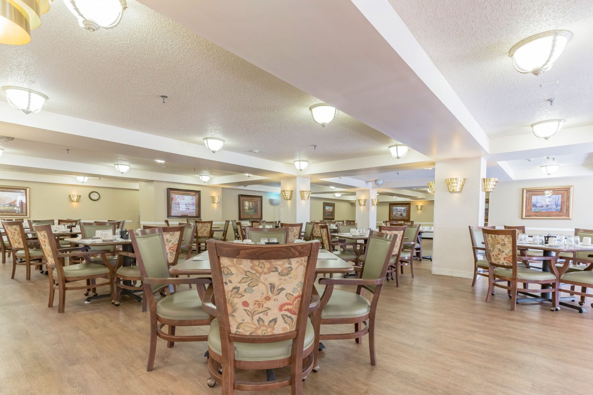 A spacious dining area with multiple tables and chairs arranged for seating.