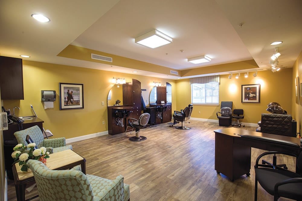 A spacious hair salon with multiple barber chairs and a comfortable waiting area.