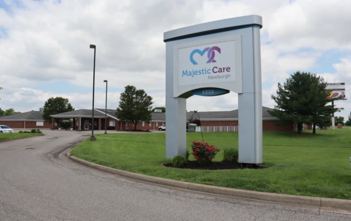 Entrance sign for Hospice Care facility with landscaped surroundings.