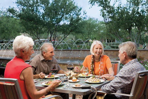 A group of friends enjoying a meal together outdoors.