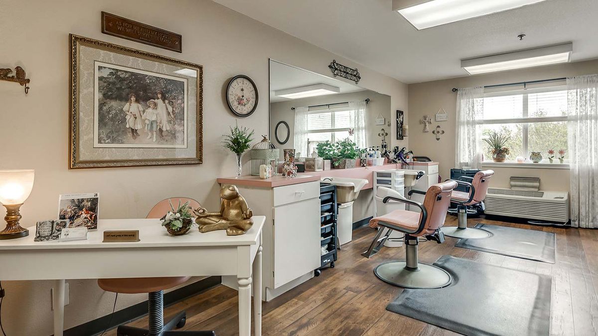 A cozy beauty salon interior with styling chairs, mirrors, and decorative elements.