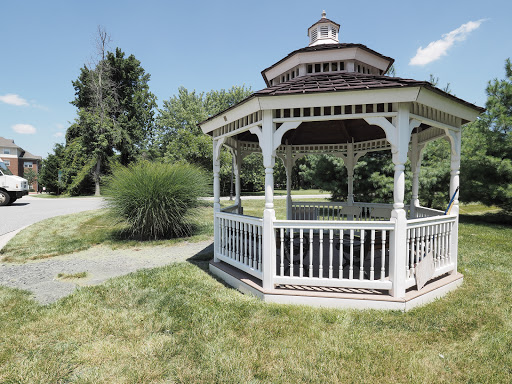 A charming gazebo situated in a lush green park, perfect for relaxation and enjoying nature.
