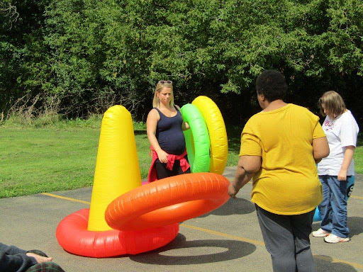 Two people enjoying a day of playful activities with inflatable cones and rings.