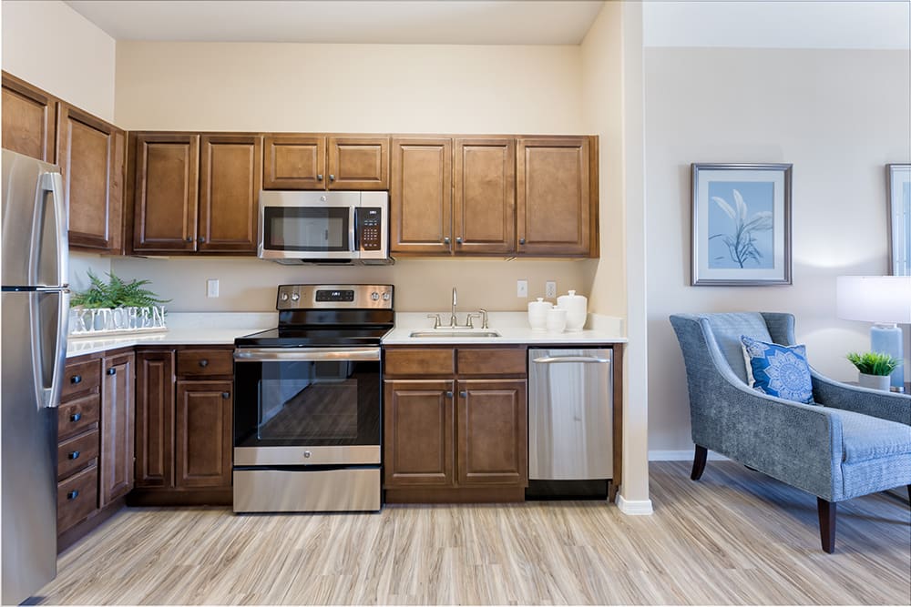 A modern kitchen with stainless steel appliances and wooden cabinets.