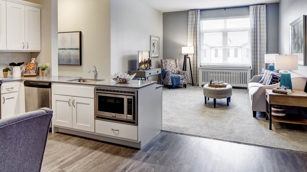 A modern open-plan kitchen and living room area in a stylish apartment.