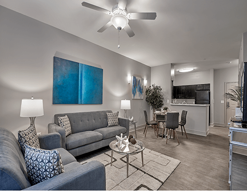 A modern apartment living room with stylish decor and a cozy dining area.
