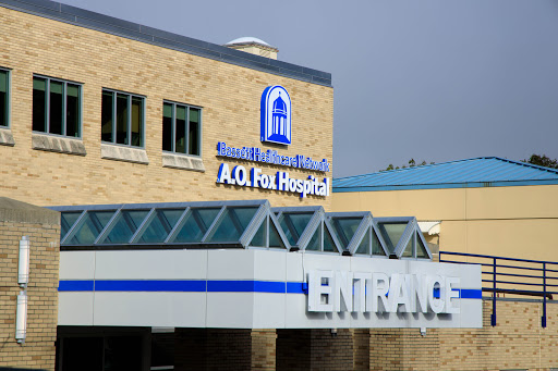 The entrance of a healthcare facility, showcasing the hospital's name prominently.